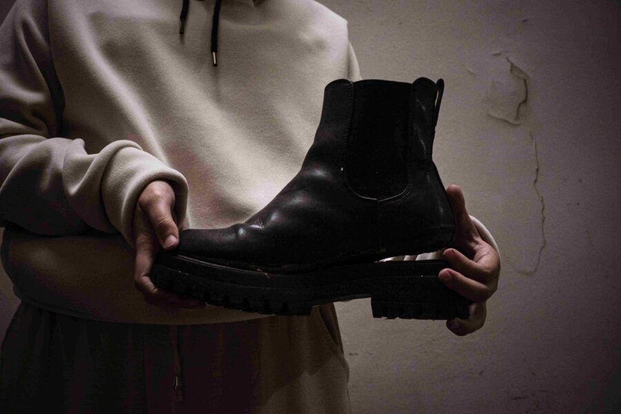 El objeto más significativo del viaje, según Lucía, fueron sus botas, destrozadas por completo: suelas despegadas que nunca se quitó porque no tenía cambio de ropa. Foto: Ella Fernández.